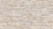 Brick wall seamless texture. Beige stone pattern background
