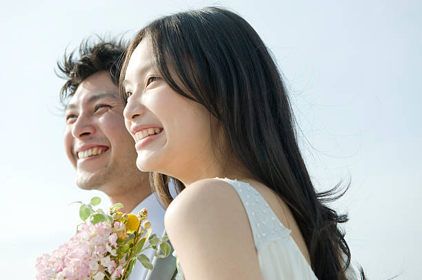 bride and groom smiling, looking away, close up - asian lovers stock pictures, royalty-free photos & images