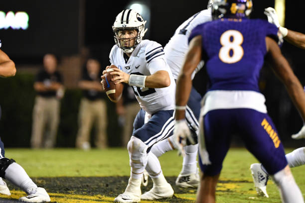 Brigham Young Cougars quarterback Tanner Mangum scrambles with the ball during a game between the BYU Cougars and the East Carolina Pirates at...