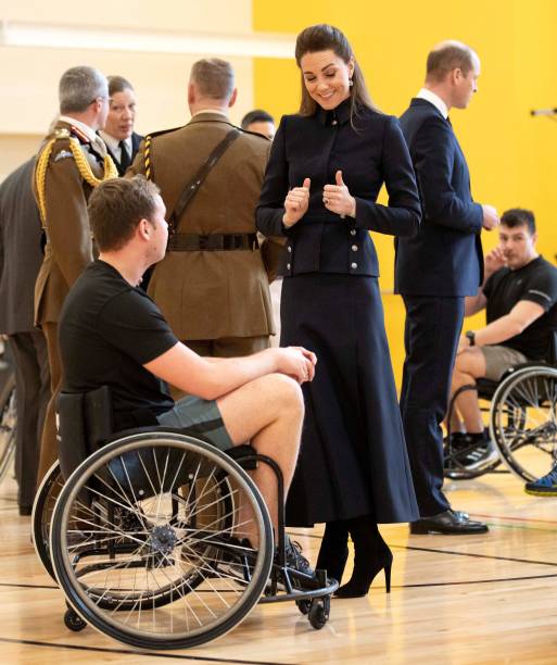 Britain's Catherine Duchess of Cambridge and Britain's Prince William Duke of Cambridge talk to patients taking part in wheelchair basketball during...