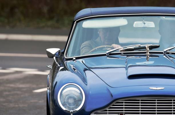 Britain's Prince Charles Prince of Wales drives his Aston Martin DB6 as he arrives for a visit to the new Aston Martin Lagonda factory in Barry Wales...