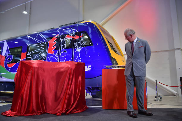 Britain's Prince Charles Prince of Wales looks at a model train presented to him during a visit to the CAF train factory in Newport Wales on February...