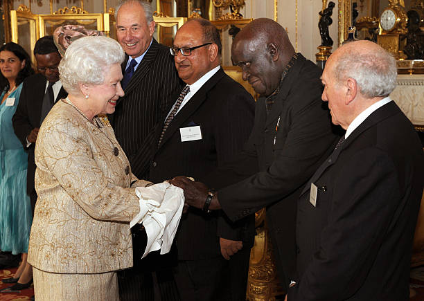 Britain's Queen Elizabeth II greets the former President of Zambia Dr Kenneth Kaunda as she hosts a reception to mark the 60th anniversary of the...