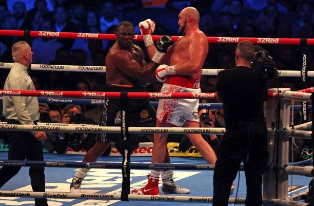 Britain's Tyson Fury lands a punch to knockout Britain's Dillian Whyte in the sixth round and win their WBC heavyweight title fight at Wembley...
