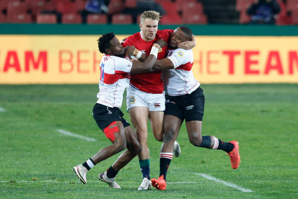 British and Irish Lions' Scottish centre Chris Harris (C) is tackled by Lions' flanker Sbusiso Sangweni (R) and Lions' wing Rabz Maxwane (L) during the rugby union tour match between the Lions and the British and Irish Lions at the Ellis Park stadium in Johannesburg on July 3, 2021. (Photo by PHILL MAGAKOE / AFP) (Photo by PHILL MAGAKOE/AFP via Getty Images)