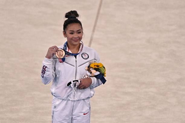 Bronze medallist USA's Sunisa Lee poses on the podium of the artistic gymnastics women's uneven bars final of the Tokyo 2020 Olympic Games at the...