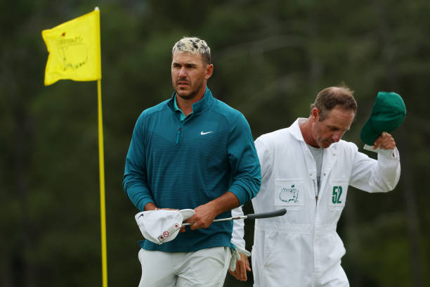 Brooks Koepka walks off the 18th green after finishing his round during the second round of The Masters at Augusta National Golf Club on April 08,...