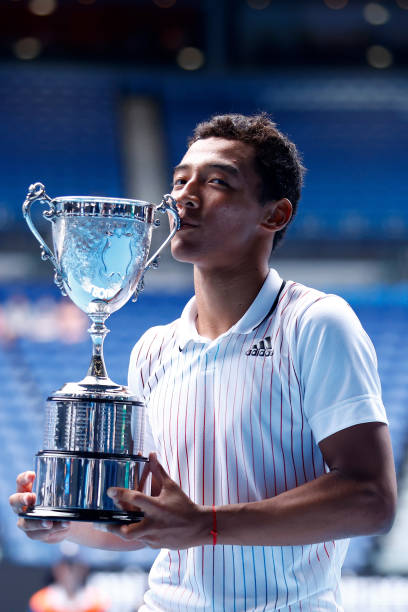 Bruno Kuzuhara of United States poses with the champions trophy after winning the Junior Boy’s Singles Final against Jakub Mensik of Czech Republic...
