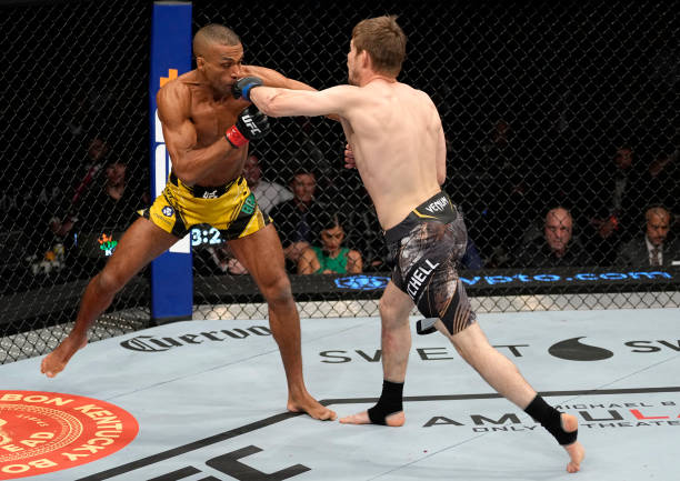 Bryce Mitchell drops Edson Barboza of Brazil with a punch in their featherweight fight during the UFC 272 event on March 05, 2022 in Las Vegas,...