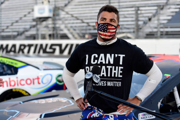 Bubba Wallace, driver of the Richard Petty Motorsports Chevrolet, wears a "I Can't Breathee - Black Lives Matter" t-shirt under his fire suit in...