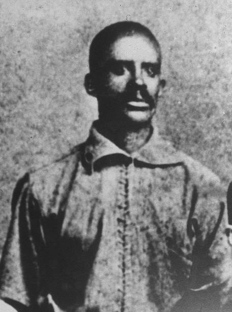 Bud Fowler poses in his Keokuk, Iowa baseball club uniform in 1885, the first professional African American baseball player.