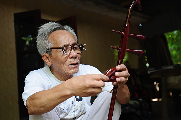 Bui Van Vuoc sets up parts of a dan nhi instrument at his workshop in Vinh Bao on September 19 2015 in Hai Phong Vietnam 81yearsold Bui Van Vuoc of...