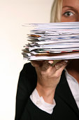 Business woman holding stack of Junk Mail and unpaid bills