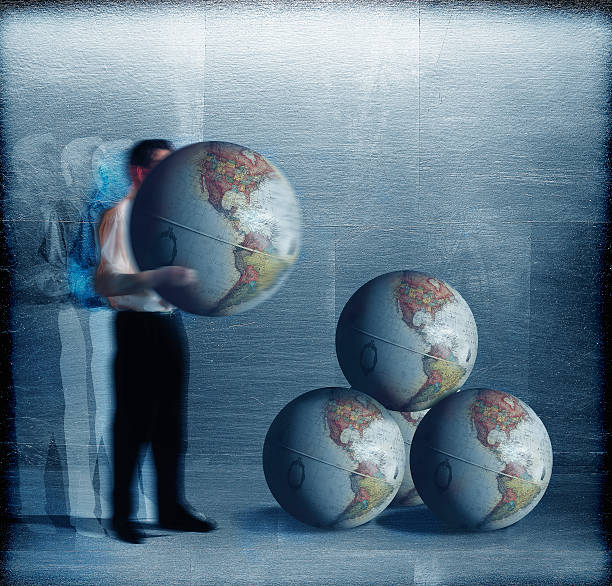 Businessman Stacking World Globes