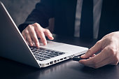 Businessman using flash drive connect to laptop