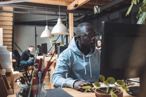 businessman working on computer at workplace - black web developer stock pictures, royalty-free photos & images