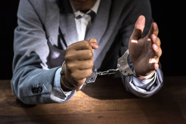 businessmen arrested,businessman with handcuffs - fraud job stock pictures, royalty-free photos & images