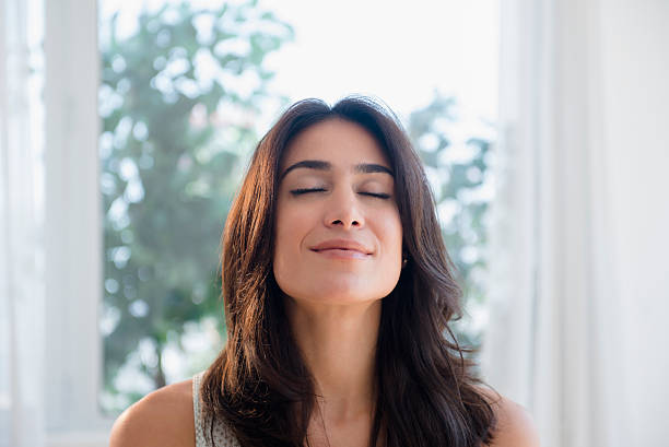 calm woman breathing with eyes closed - breath stock pictures, royalty-free photos & images
