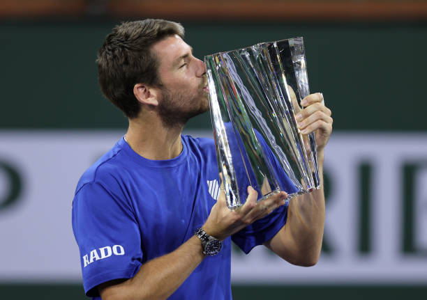 Cameron Norrie of Great Britain kisses his winners trophy after his three set victory against Nikoloz Basilashvili of Georgia in the men's final...