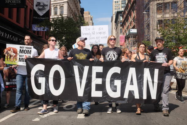 Campaigners for animal rights form part of the Official Animal Rights March protest in downtown Manhattan, New York with a banner that reads 'Go...