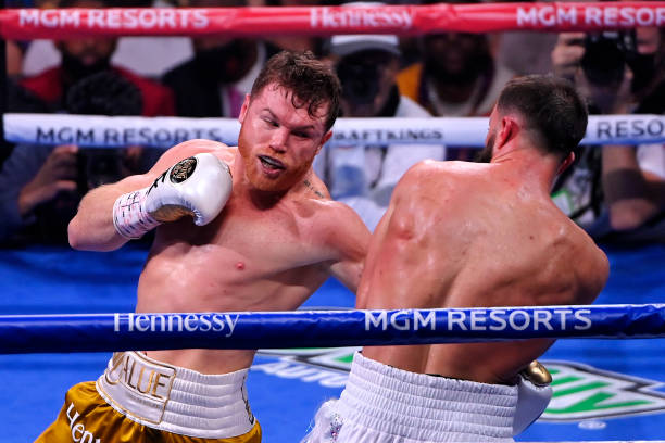 Canelo Alvarez punches Caleb Plant during their championship bout for Alvarez's WBC, WBO and WBA super middleweight titles and Plant's IBF super...
