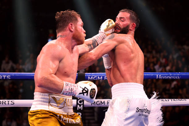 Canelo Alvarez punches Caleb Plant during their championship bout for Alvarez's WBC, WBO and WBA super middleweight titles and Plant's IBF super...