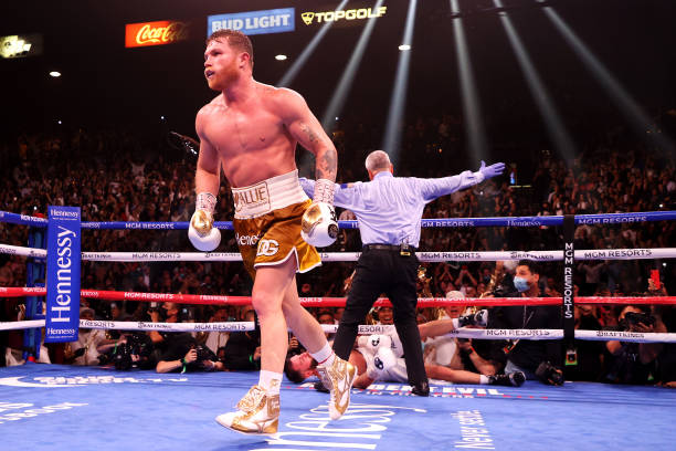 Canelo Alvarez walks away after knocking out Caleb Plant in the 11th round during their championship bout for Alvarez's WBC, WBO and WBA super...