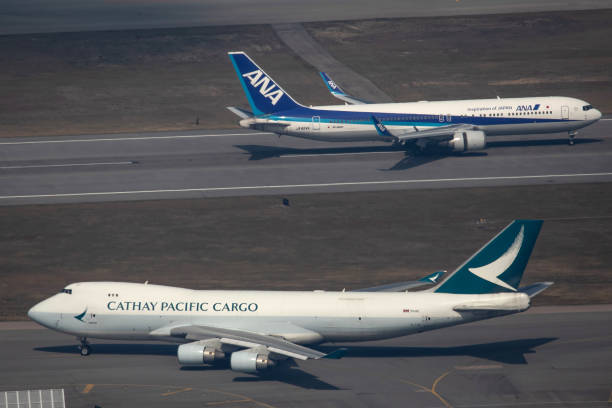cargo aircraft operated by cathay pacific airways ltd taxis past a picture id1237562107?k=20&m=1237562107&s=612x612&w=0&h=PhSgdlD1ee5kYwLQNpqkKcRyfjnqcNGFqMq jsHiCXU=