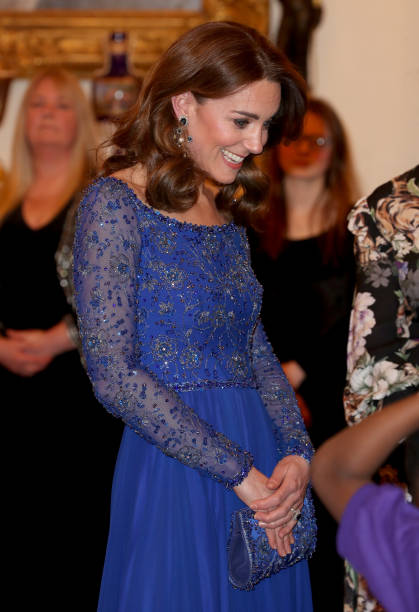 Catherine Duchess of Cambridge speaks with a school choir as she hosts a Gala Dinner in celebration of the 25th anniversary of Place2Be at Buckingham...