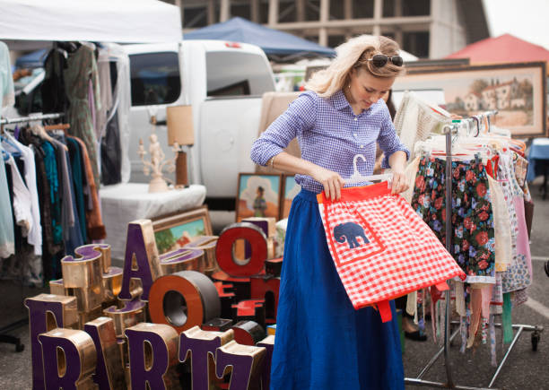 caucasian woman shopping for apron in flea market picture