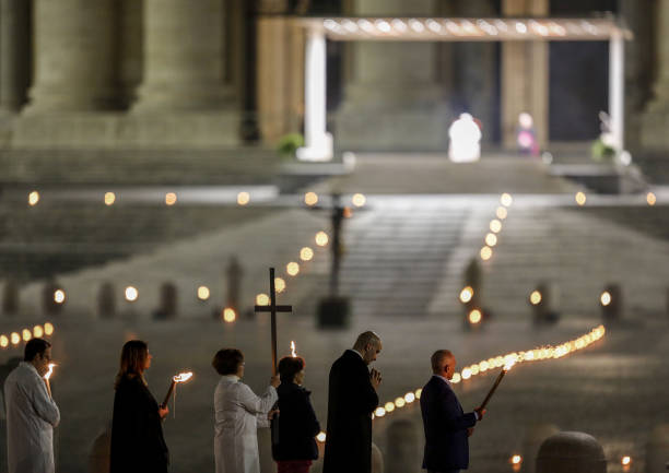 Celebrants walk in St. Peter's Square during the rehearsal of the Via Crucis torchlight procession presided by Pope Francis to commemorate the...