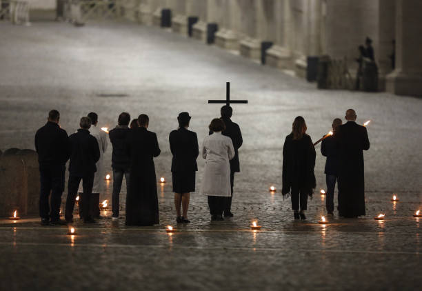 Celebrants walk in St. Peter's Square during the Via Crucis torchlight procession presided by Pope Francis to commemorate the crucifixion of Jesus...