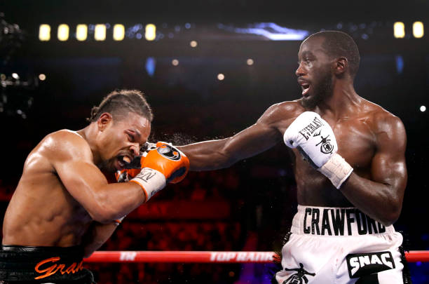 Champion Terence Crawford punches Shawn Porter during their welterweight title fight at Michelob ULTRA Arena on November 20, 2021 in Las Vegas,...
