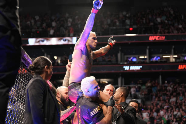 Charles Oliveira celebrates his victory over Justin Gaethje in their Lightweight bout during the UFC 274 event at Footprint Center on May 7 in...