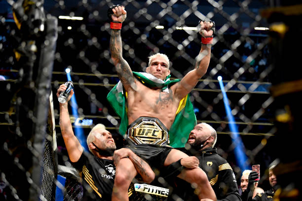 Charles Oliveira of Brazil reacts after being announced the winner by submission against Dustin Poirier after their UFC lightweight championship bout...