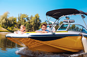 Cheerful little siblings enjoying view from boat bow