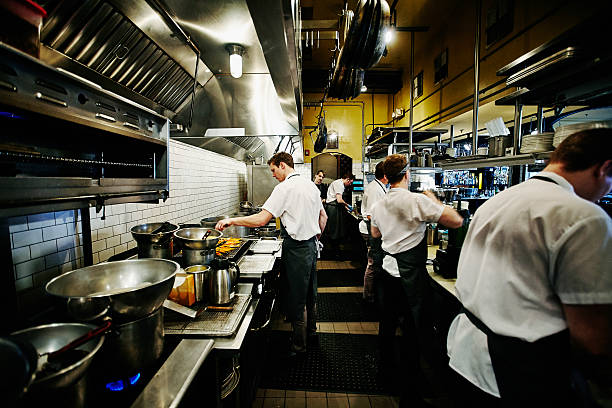 chef and kitchen staff preparing dinner in kitchen picture