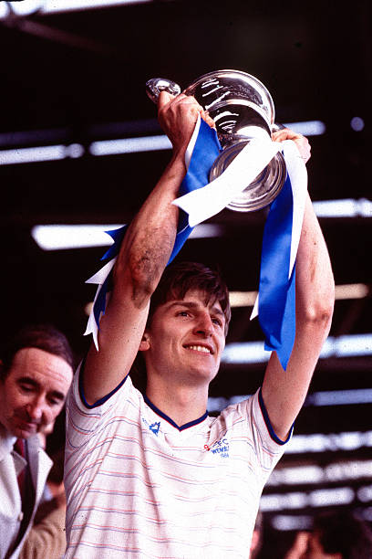 Chelsea captain Colin Pates lifts the Full Members' Cup trophy.