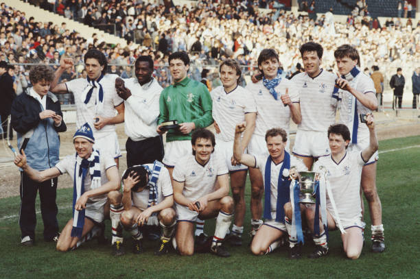 Chelsea Football Club team players celebrate with the Full Members' Cup on the pitch after beating Manchester City 5-4 in the 1986 Full Members' Cup...