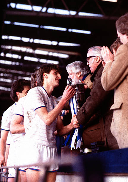 Chelsea's Colin Pates collects the Cup from Sir Richard Attenborough.