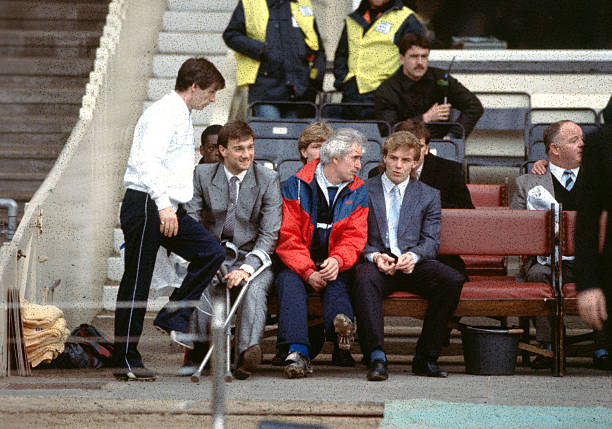 Chelsea's goalkeeping coach Peter Bonetti on the team bench with the injured Kerry Dixon, who missed the game.