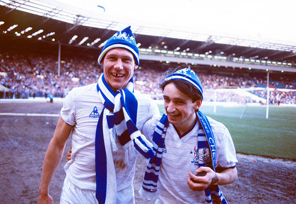 Chelsea's Pat Nevin and Doug Rougvie celebrate after the game in possession.