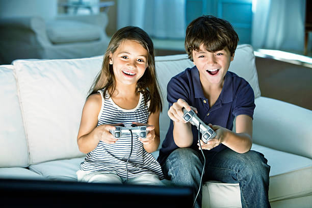 Children playing video game at home