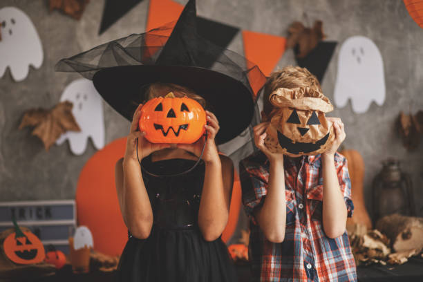 children playing with halloween decoration - halloween stock pictures, royalty-free photos & images