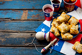 Chilean independence day concept. fiestas patrias. Chilean typical dish and drink on independence day party, 18 september. Mini empanadas, mote con huesillo, wine with toasted flour, chicha and tipical play emboque