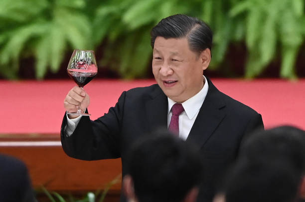 Chinese President Xi Jinping raises his glass after a speech by Premier Li Keqiang at a reception at the Great Hall of the People in Beijing on the...