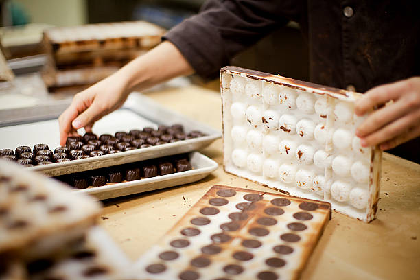 chocolate production - chocolate maker stock pictures, royalty-free photos & images