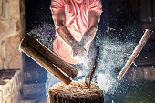 Chopping Wood with an explosion of Dust.