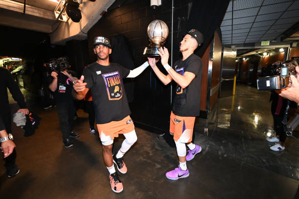 Chris Paul and Devin Booker of the Phoenix Suns celebrate after winning the Western Conference Finals of the 2021 NBA Playoffs on June 30, 2021 at...