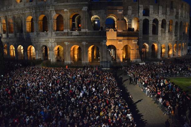 Christians attend the Via Crucis torchlight procession in front of the Colosseum on Good Friday, on April 14, 2017 in Rome, Italy. Christians around...